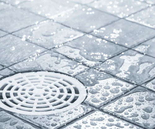 What are the benefits of installing linear drains compared to traditional floor drains?